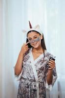 Woman applying facial mask on her face. Skin care concept photo