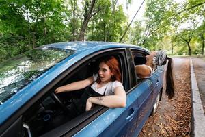 Two girlfriends fool around and laughing together in a car photo