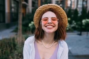 Young woman with toothy smile in outdoors photo