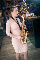 Beautiful girl playing saxophone photo