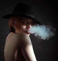 Portrait of a young girl in the smoke of cigarettes photo