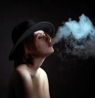 Portrait of a young girl in the smoke of cigarettes photo