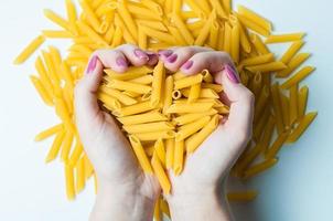 The hands of the chef holding in his hands Italian pasta photo