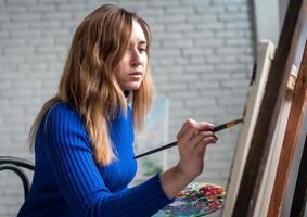 Female student having classes at art studio, to draw. photo