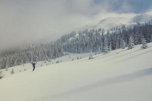 Happy skier on mountain slope landscape photo