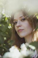 Close up woman with bright makeup surrounded by white flowers portrait picture photo