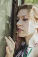 Close up pretty woman touching muddy window with fingertips portrait picture photo