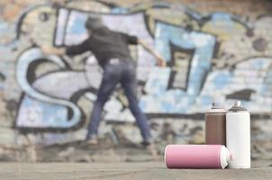 A still-life of several used paint cans of different colors agai photo