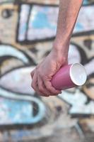 Photo of the hand of a street artist who draws a new color pictu