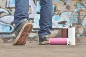 A still-life of several used paint cans of different colors agai photo