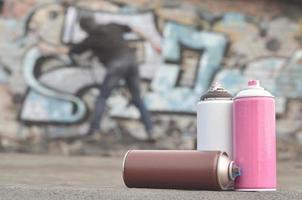 A still-life of several used paint cans of different colors agai photo