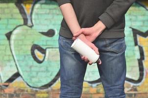 A photo of a street artist who draws a new colored picture on a