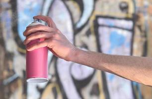 Photo of the hand of a street artist who draws a new color pictu