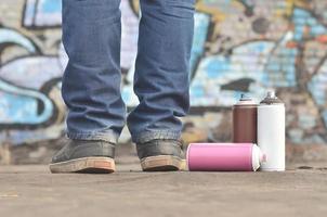 A still-life of several used paint cans of different colors agai photo