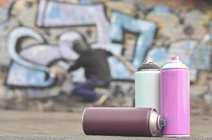 A still-life of several used paint cans of different colors agai photo