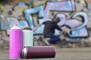 A still-life of several used paint cans of different colors agai photo