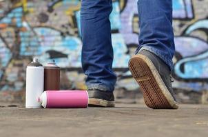 A still-life of several used paint cans of different colors agai photo