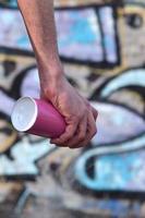 Photo of the hand of a street artist who draws a new color pictu