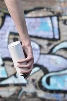 Photo of the hand of a street artist who draws a new color pictu