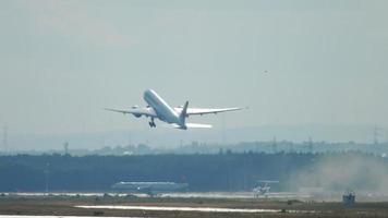 FRANKFURT AM MAIN, GERMANY JULY 20, 2017 - Air Canada Boeing 777 climb up at 25C, rainy weather, slow motion. Fraport, Frankfurt, Germany video