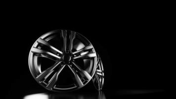 Metal car wheels on a black background. video