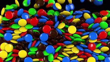 Round multicolored candies fill the container video