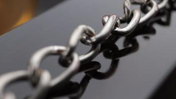 Close up of metal chain links conveying the message of power or entrapment video