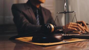 justice and law concept.Male judge in a courtroom on wooden table and Counselor or Male lawyer working in office. Legal law, advice and justice concept. video