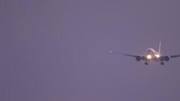 Widebody airplane approaching before landing on the Phuket airport against sunset sky. View from the top floor of the hotel near airport video