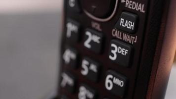 Modern residenstial cordless button phone with a digital display and clicky buttons video