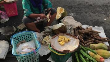 A jackfruit seller is peeling the skin to sell at a traditional market video