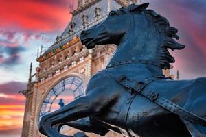 Close up view of the Big Ben clock tower and horse statue monument in the foreground. photo