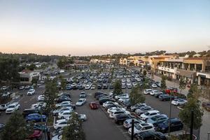 High angle view of vehicles at parking lot in city during sunset photo