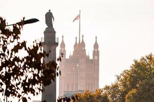 The very symbol of London. Westminster Abby with UK flag and Duke of York monument. photo