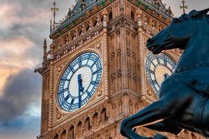 Close up view of the Big Ben clock tower and horse statue monument in the foreground. photo