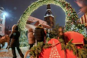 People enjoy Christmas market in winter Riga in Latvia. photo