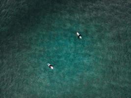 Surfers at Unstad Beach in the Lofoten Islands in Norway photo