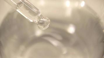 Drop of liquid drop from pipette into water video