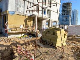 External insulation for the walls of the house. Construction site. Production of apartments, social housing. photo