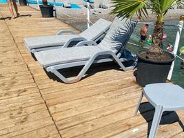 Comfortable sun loungers on sea beach at resort photo