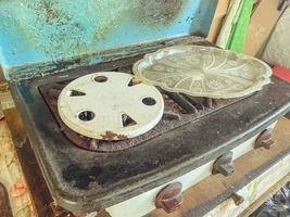 old gas stove for cooking. burners for gas, pans. two places for cooking. garden appliances for the kitchen. small stove photo