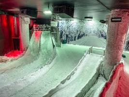 snow room. on the snow a hill for people to ride. entertainment in the snow room. extreme slides with ice, rapid descent down photo