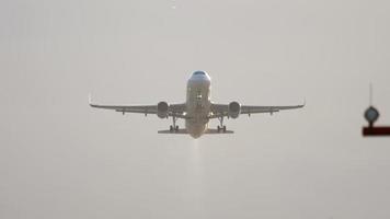 DUSSELDORF, GERMANY JULY 23, 2017 - Airbus A320 of Eurowings takes off early in the morning with sun lighting. The passenger plane takes off and retracts the landing gear. video