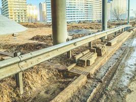 bridge in the new neighborhood. concrete bridge on beams, near dirt, puddles. bridge construction. construction of infrastructure in a new microdistrict photo