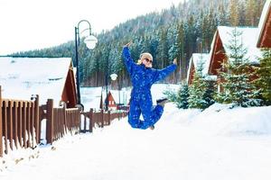 woman in winter park, houses in the forest photo