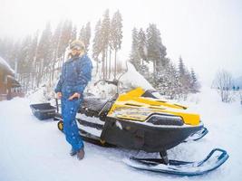 Portrait of woman on snowmobile.Concept of snow sport and healthy lifestyle photo