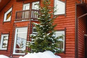 wooden house in winter forest photo