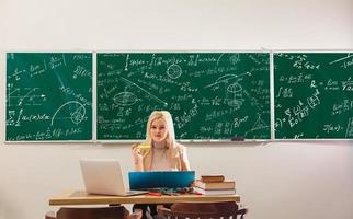 Teacher is skilled leader, Student looks for studying method that suits his learning style, Modern teacher hipster writing on big blackboard with math formula, Some students learn best by listening, photo