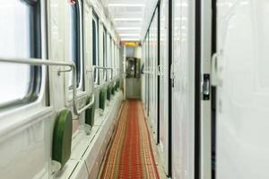 Sleeping car of a passenger train. Corridor inside the train car. photo