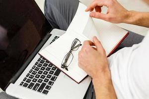 Young man puts his glasses on photo